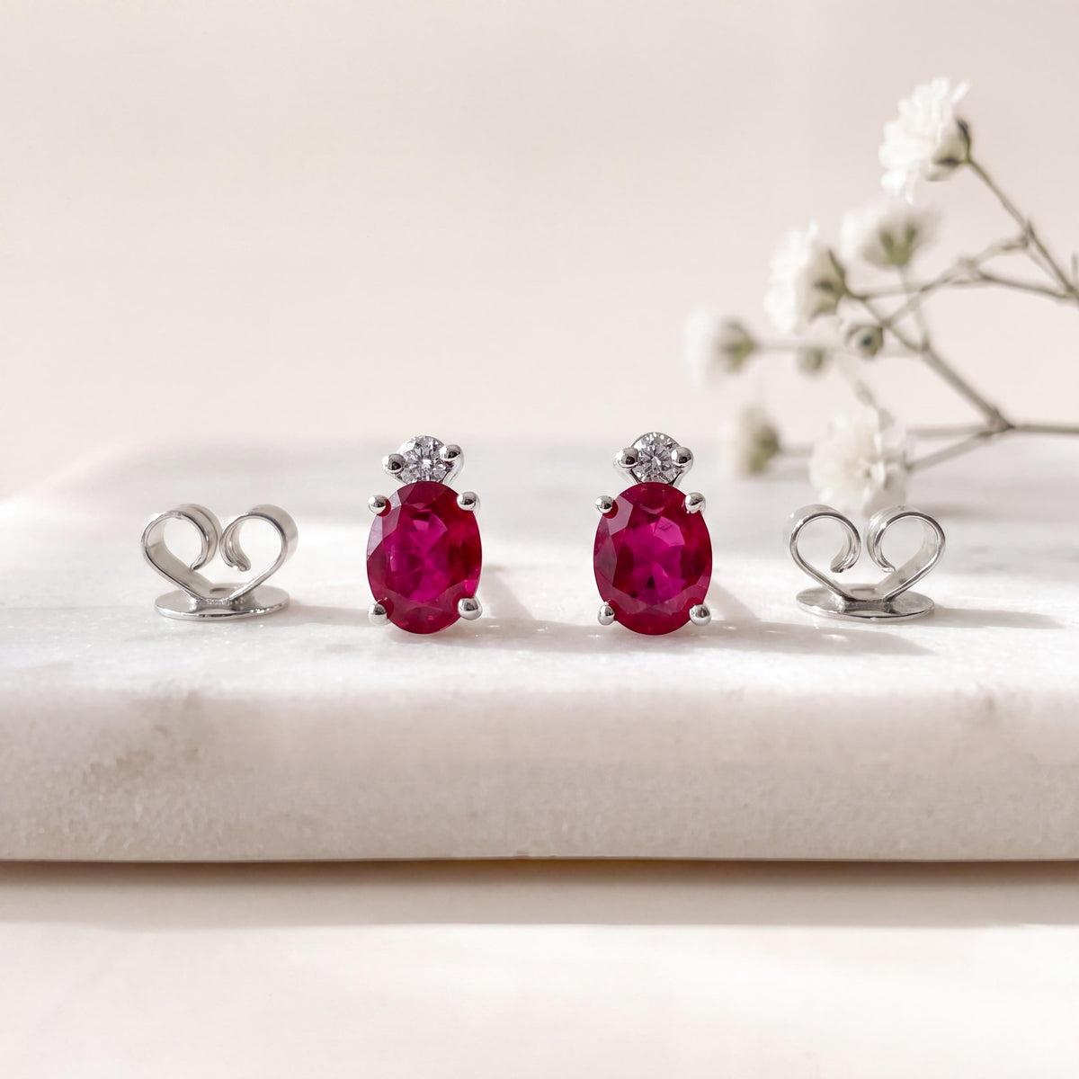 Genuine Ruby and Moving Diamond Oval Stud Earrings in 18k White Gold