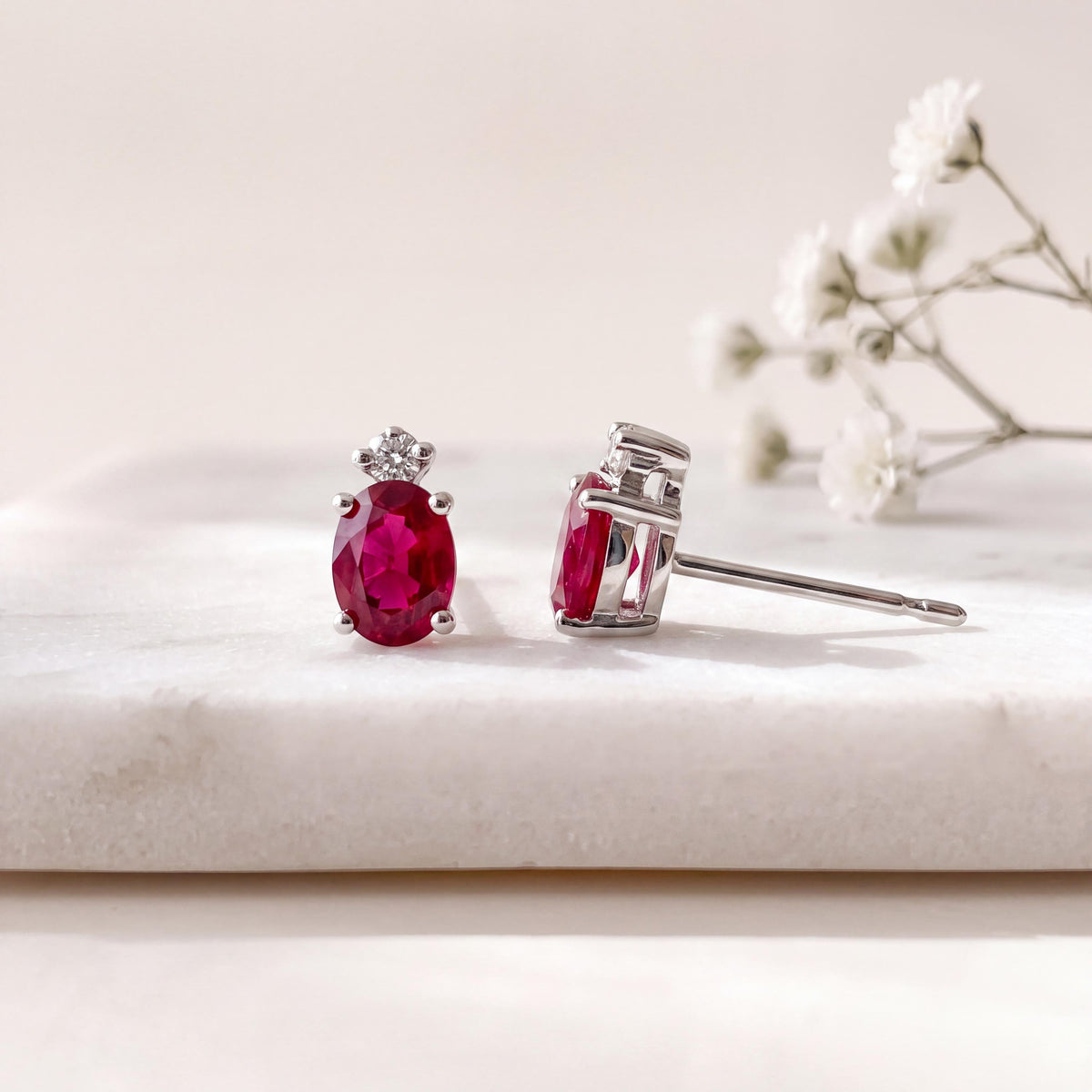 Genuine Ruby and Moving Diamond Oval Stud Earrings in 18k White Gold