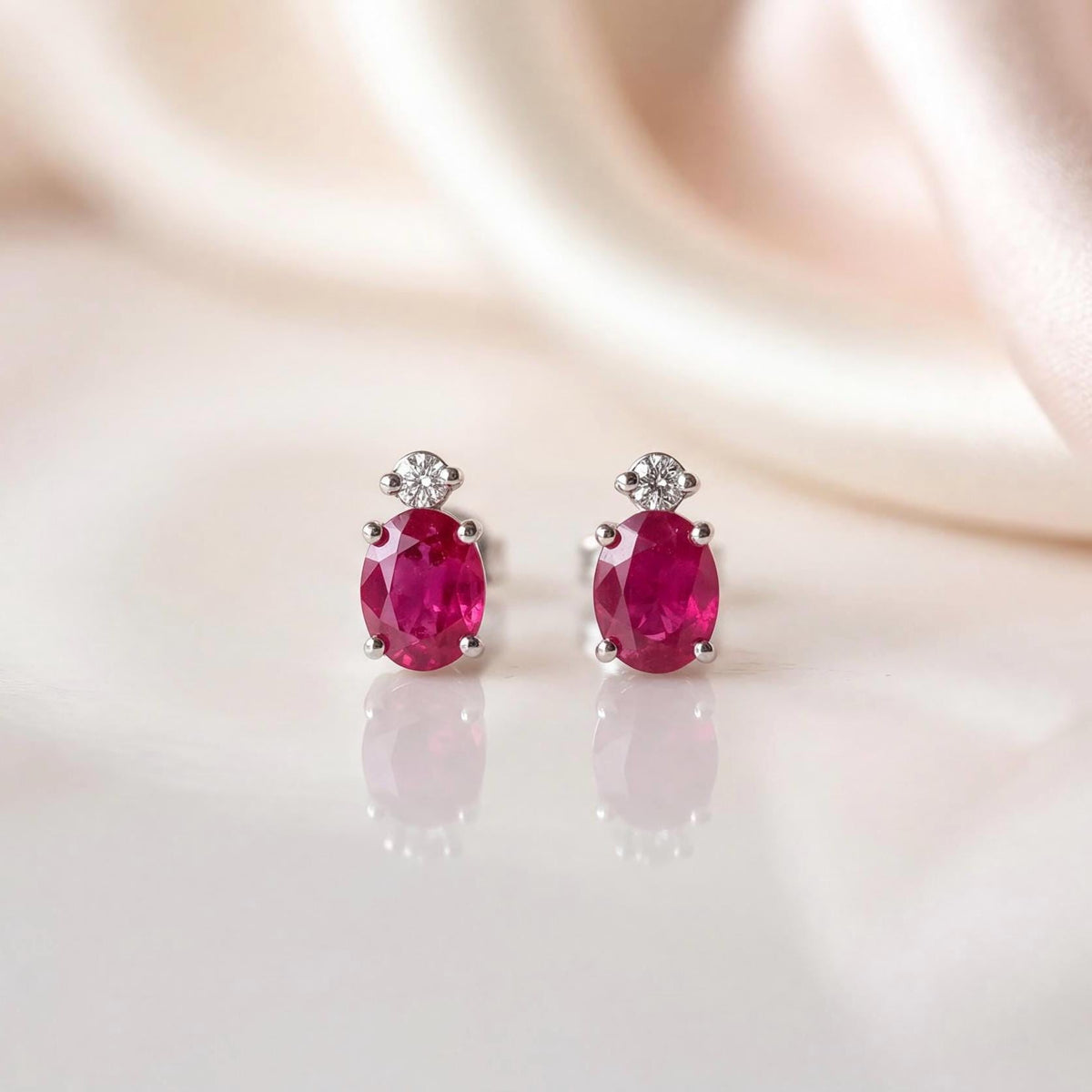 Genuine Ruby and Moving Diamond Oval Stud Earrings in 18k White Gold