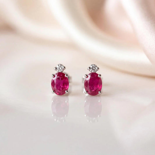 Genuine Ruby and Moving Diamond Oval Stud Earrings in 18k White Gold